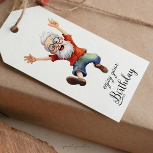 May include: A white gift tag with a cartoon illustration of a man with a white beard and glasses jumping in the air. The text "enjoy your Birthday" is written in black cursive.