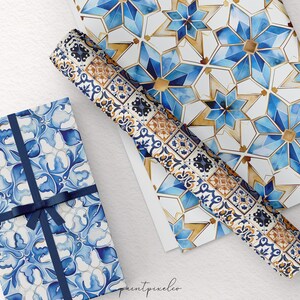 May include: Gift boxes and wrapping paper with blue and white watercolor patterns. One box is wrapped with a blue ribbon. The patterns include floral and geometric designs. A roll of matching wrapping paper is also visible.
