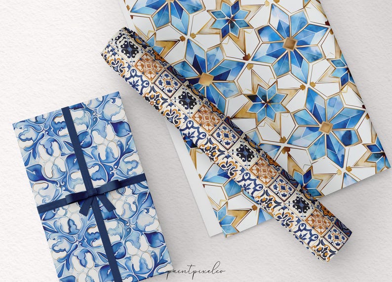 May include: Gift boxes and wrapping paper with blue and white watercolor patterns. One box is wrapped with a blue ribbon. The patterns include floral and geometric designs. A roll of matching wrapping paper is also visible.