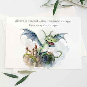 May include: A watercolor illustration of a green dragon with blue wings perched on a rocky cliff with a castle in the background. The text reads "Always be yourself unless you can be a dragon. Then always be a dragon."