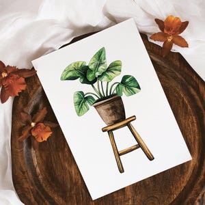 May include: Watercolor painting of a green potted plant on a wooden stool. The plant is in a brown pot and has large, green leaves. The stool is made of light brown wood and has three legs.