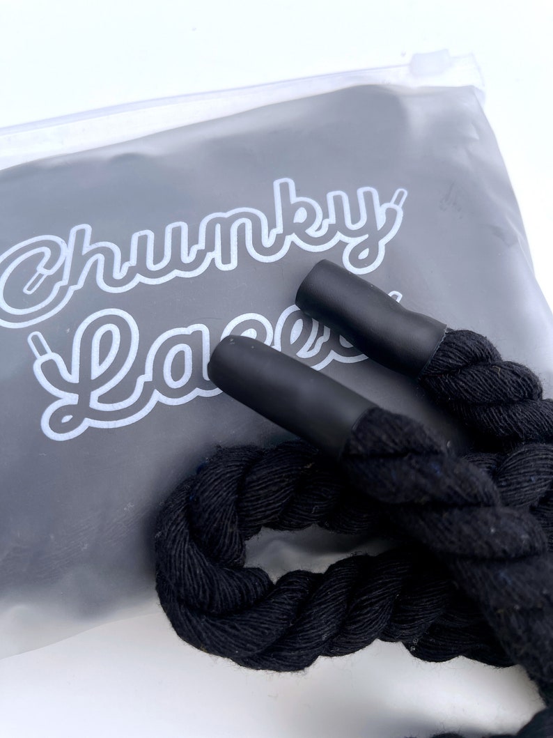 Chunky Laces Black 14mm thick shoelaces 140cm length , made from macrame twisted cotton rope, inside custom Chunky Lace packaging. These premium laces transform classic sneakers with a unique style, merging personal flair with robust aesthetics.