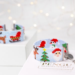 May include: A blue beaded bracelet with a Christmas theme. The bracelet features a reindeer, a snowman, a Christmas tree, and Santa Claus. The bracelet is made by Pengu Beading Jewelry.