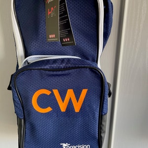 May include: A blue and black sports bag with white trim. The bag has a large "CW" in orange letters on the front and a white "precision" logo below it.