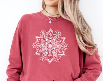 May include: Crimson-colored long-sleeve sweatshirt featuring a white mandala design on the front. The sweatshirt is paired with blue denim jeans. The word "CRIMSON" is printed in bold, black letters at the bottom right corner of the image.