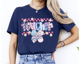 May include: Navy blue t-shirt with a colorful graphic that says "Teacher". The graphic includes a bow, flowers, and a star. The shirt is a crew neck and has short sleeves.