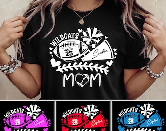 May include: Black t-shirt with a football and cheerleader design. The shirt features the text "WILDCATS", "JACK 25", and "Sophia", with the word "MOM" below. Additional designs include "SISTER", "GRANDMA", and "DAD" variations.