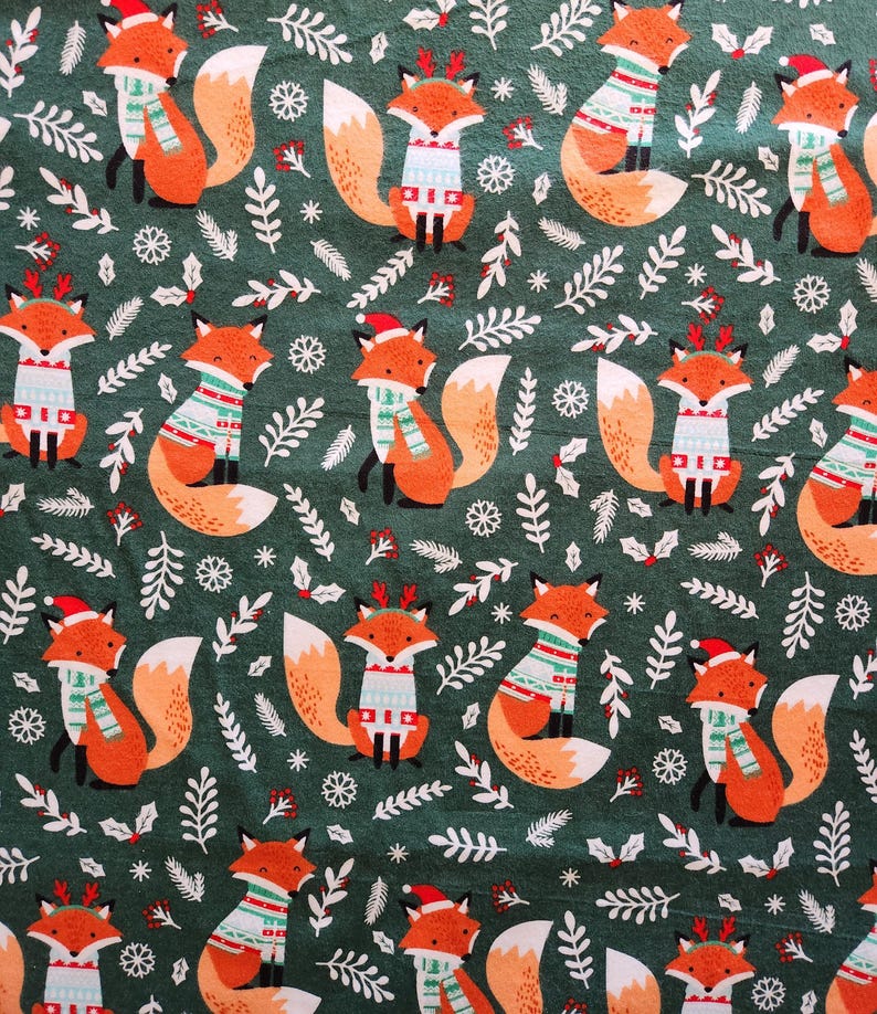 May include: A repeating pattern of cartoon foxes in festive attire, including sweaters, scarves, and Santa hats, set against a dark green background with white foliage and snowflakes. The foxes are orange and white.