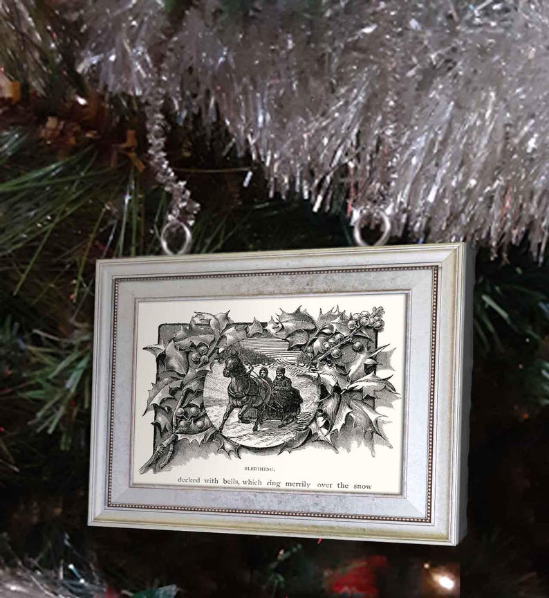 May include: A black and white vintage illustration of a horse-drawn carriage decorated with bells, framed in a silver frame with a holly border. The text below the image reads "decked with bells, which ring merrily over the snow".