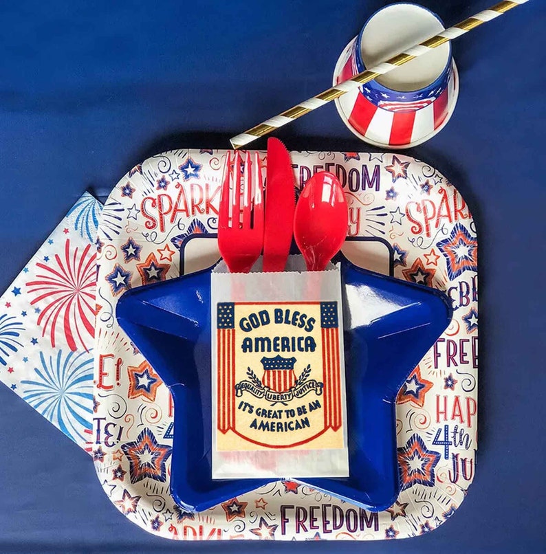 May include: A red, white, and blue themed party plate with a blue star-shaped plate on top. The plate features the text "God Bless America" and "It's Great to Be an American".