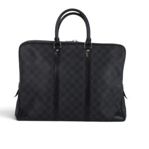 May include: A rectangular briefcase in a dark gray and black checkered pattern. The bag features two black leather top handles, vertical black leather trim accents running down the front, and reinforced black leather corners at the base.