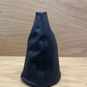 May include: Black leather gear shift boot cover.