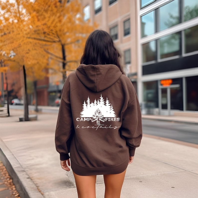 A white graphic on the back, shown on a dark brown hooded sweatshirt