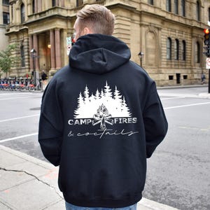 A white graphic on the back, shown on a black hooded sweatshirt