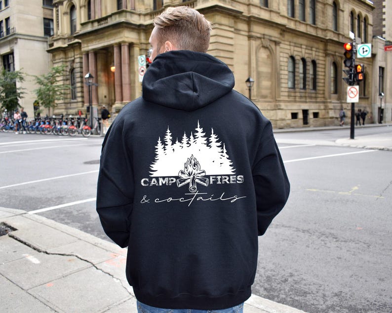 A white graphic on the back, shown on a black hooded sweatshirt