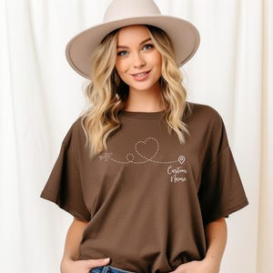 a woman wearing a brown shirt and a hat