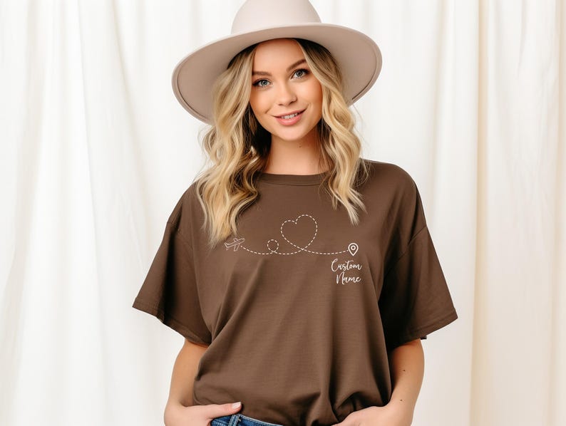 a woman wearing a brown shirt and a hat