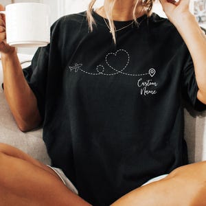 a woman sitting on a couch holding a cup of coffee