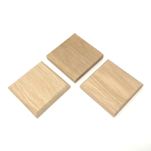 May include: Three square wooden coasters made of light brown oak wood.