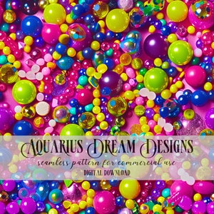 May include: A seamless pattern featuring a variety of colorful, shiny, and textured round beads. The beads are arranged in a random pattern on a pink background. The text "AQUARIUS DREAM DESIGNS" and "seamless pattern for commercial use" is displayed on a white banner.