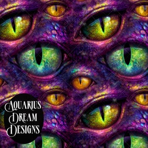 May include: A digital art design featuring multiple reptilian eyes in shades of green, yellow, and orange, set against a purple and blue textured background. The design includes the text "Aquarius Dream Designs" in a circular black shape.