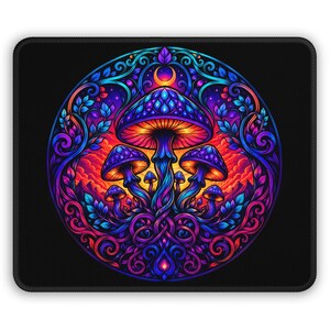 May include: A rectangular mouse pad featuring a circular design with a central cluster of mushrooms in vibrant shades of blue, purple, and orange. The artwork includes intricate swirling vine patterns, leaves, and a crescent moon against a black background.