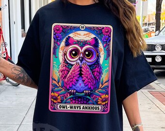 May include: Black t-shirt featuring a graphic of a pink owl wearing glasses, with the text "Owl-Ways Anxious" in a vintage tarot card style.