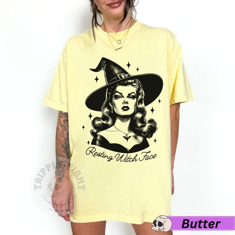 May include: A yellow t-shirt with a black and white illustration of a witch with the text "Resting Witch Face".
