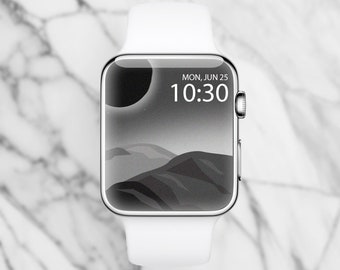 May include: A white Apple Watch with a black and white landscape watch face. The time is 10:30 and the date is MON, JUN 25.