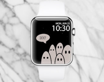 May include: A white Apple Watch with a black watch face displaying the time 10:30 and the date MON, JUN 25. The watch face also features a cartoon ghost with the word "BOO!" in a speech bubble and several other ghosts.