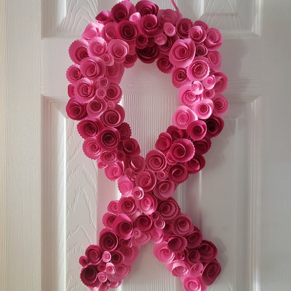 Breast cancer awareness ribbon wreath made with rolled paper flowers in varying shades of pink.  Message me with your custom color options!