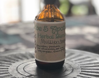 May include: A brown glass bottle with a dropper top and a white label that reads "Tribe 5 Apothecary Herbal Blend Mullien Tincture". The label also lists the benefits of the tincture, including "Respiratory Problems, Anti-inflammatory, Anti-viral, Lung congestion, removes phlegm".