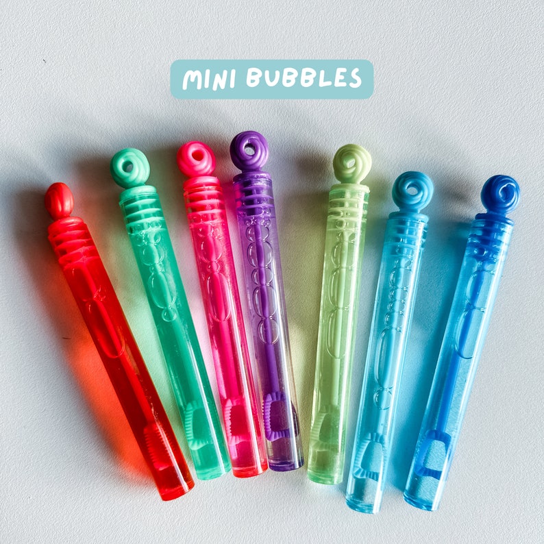 May include: Seven colorful plastic bubble wands with a white label that reads "MINI BUBBLES". The wands are arranged in a row, with the red wand at the top and the blue wand at the bottom.