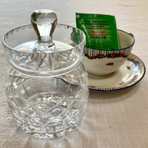May include: A set of three ceramic mugs with a speckled, matte finish. The mugs are in shades of cream, light gray, and dark gray. Each mug has a simple, minimalist design, perfect for coffee or tea.