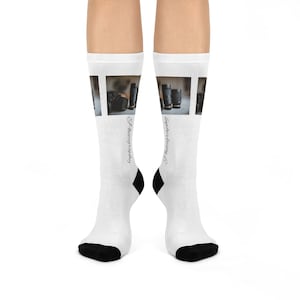 May include: White socks with a black toe and heel. The socks feature a photographic image of camera lenses and the text "Photography" on each side.