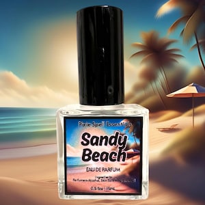May include: A clear glass bottle of "Sandy Beach" Eau de Parfum by Pixie Spell Essentials. The bottle is 0.5 oz or 15 ml and has a black cap. The label features a beach scene with palm trees and a beach umbrella.