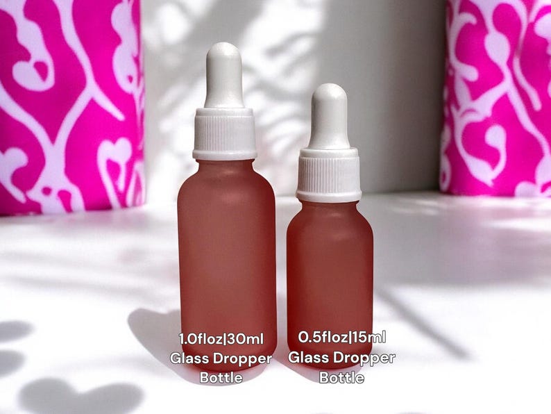May include: Two frosted glass dropper bottles with white caps. The larger bottle is labeled "1.0 fl oz / 30 ml Glass Dropper Bottle" and the smaller bottle is labeled "0.5 fl oz / 15 ml Glass Dropper Bottle".