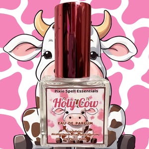 May include: A clear glass perfume bottle with a metallic red cap. The label features the text Pixie Spell Essentials, Holy Cow, Eau de Parfum, and lists ingredients with a volume of 0.5 fl oz | 15 ml. A cartoon cow illustration is on the label.
