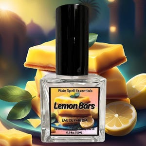 May include: A clear glass bottle of Lemon Bars Eau de Parfum by Pixie Spell Essentials. The bottle is 0.5 fl oz / 15mL and features a black cap. The label has a yellow and white illustration of lemon bars and lemons.