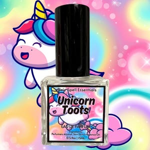 May include: A clear glass perfume bottle with a black cap, labeled "Unicorn Toots" with a cartoon unicorn graphic. The label also includes "EAU DE PARFUM" and ingredient information. The background is a colorful, pastel rainbow with a cartoon unicorn.