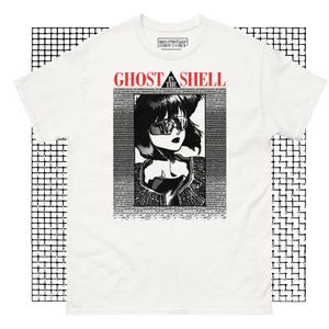 May include: White t-shirt featuring a black and white illustration of a woman wearing sunglasses. The text "Ghost in the Shell" is printed in red above the illustration.