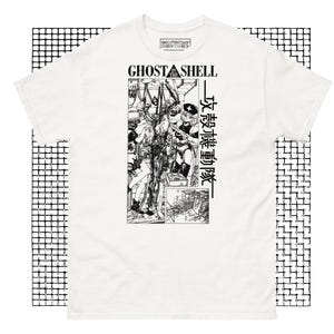 May include: White t-shirt featuring a black and white graphic print of a scene from the anime "Ghost in the Shell". The text "Ghost in the Shell" is printed in black above the graphic. The Japanese text "攻殻機動隊" is printed to the right of the graphic.