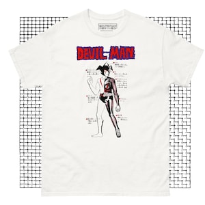 May include: White t-shirt with a black and white illustration of Devilman, a Japanese manga character. The illustration includes Japanese text and a diagram of the character's body.