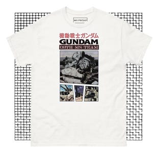 May include: White t-shirt with a black and white graphic print of a robot from the anime series "Mobile Suit Gundam". The text "機動戦士ガンダム GUNDAM 08th MS TEAM" is printed in pink on the shirt.