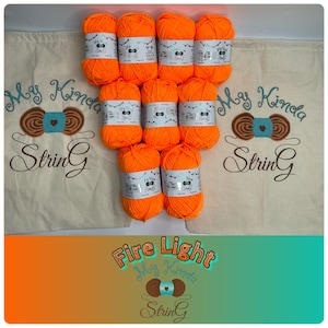 May include: Ten orange skeins of yarn labeled "My Kinda String" in a white drawstring bag. The yarn is labeled "Fire Light".