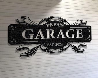 May include: Black metal sign with the text "Papa's Garage Est. 2024" and a design of crossed wrenches and a chain.