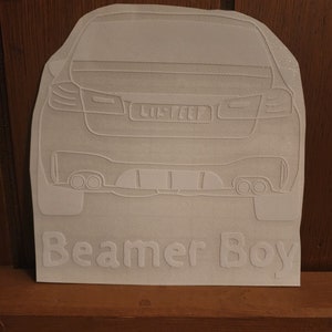 May include: White vinyl sticker of a car's rear end with the text "Beamer Boy" underneath.