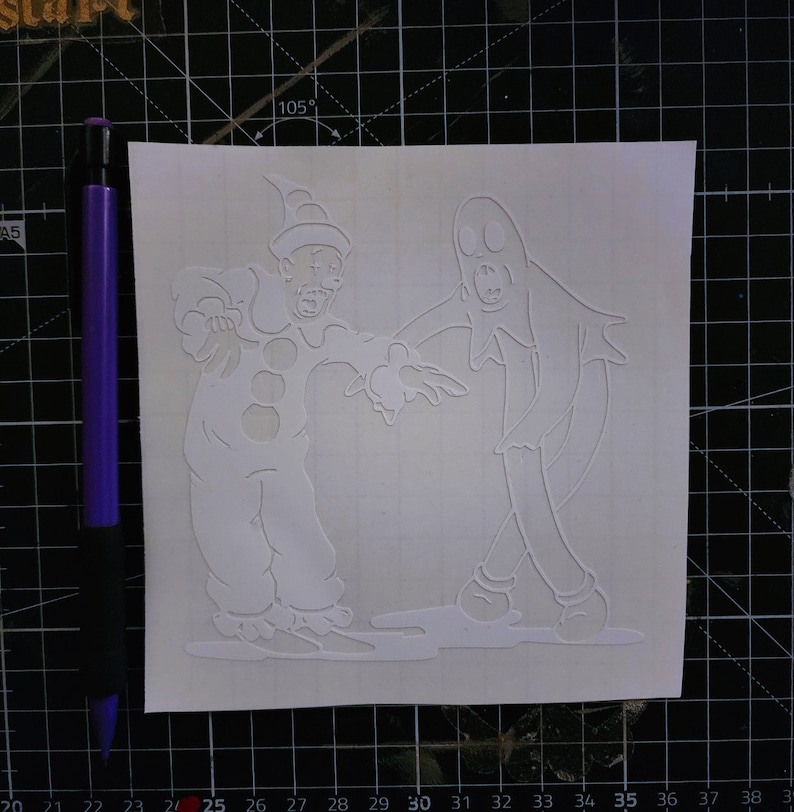 May include: A white vinyl sticker featuring a spooky clown and a ghost. The clown is wearing a hat and has a wide smile. The ghost is wearing a sheet and has a surprised expression.