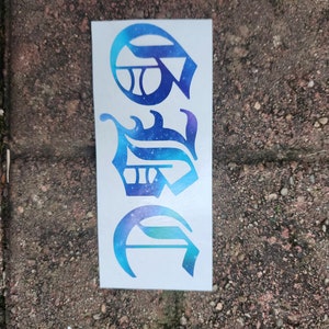 May include: A white sticker featuring three stylized letters in a gradient of blue and purple, resembling a celestial design. The letters are in a unique, ornate font, with a space-themed aesthetic.