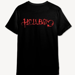 May include: Black t-shirt with a red graphic print of the word "HELLBOY" in a stylized font with a devil tail.